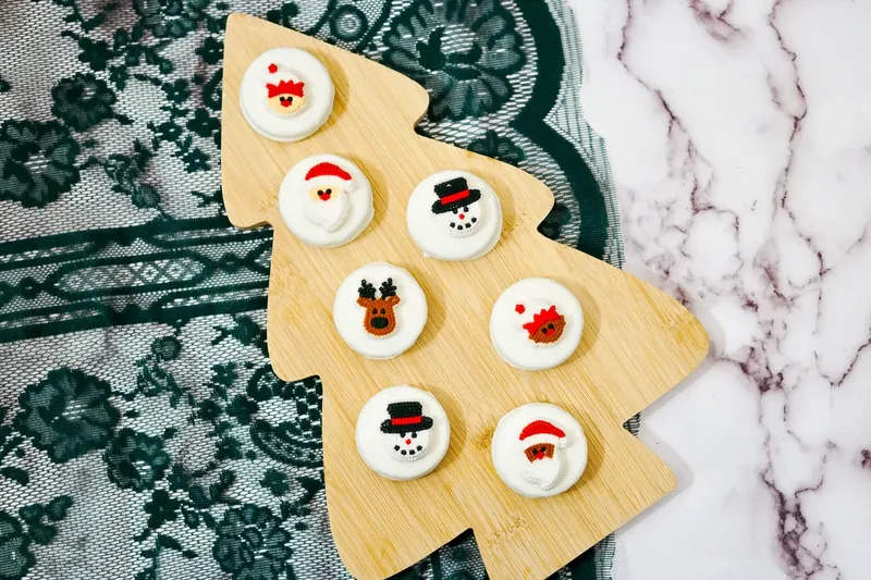 White chocolate Oreos with Christmas character candy designs attached