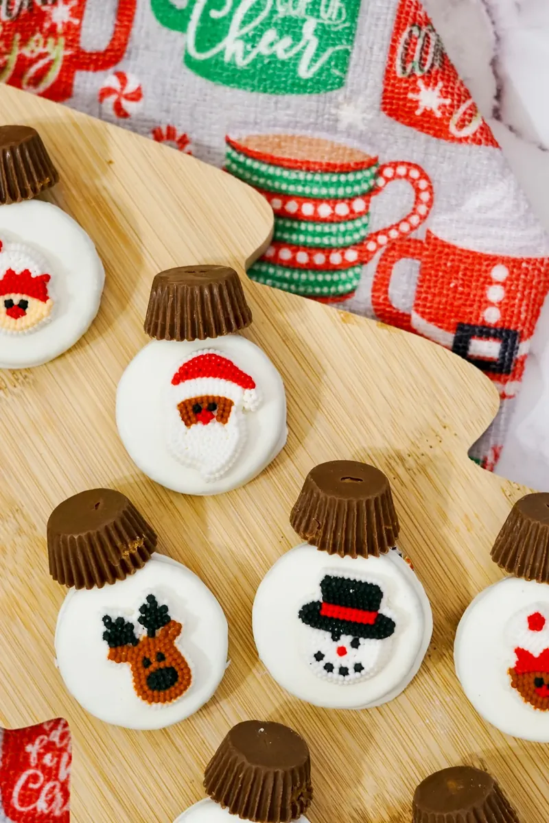 Close up view of Christmas ornament Oreos showing Santa, snowman, and reindeer designs