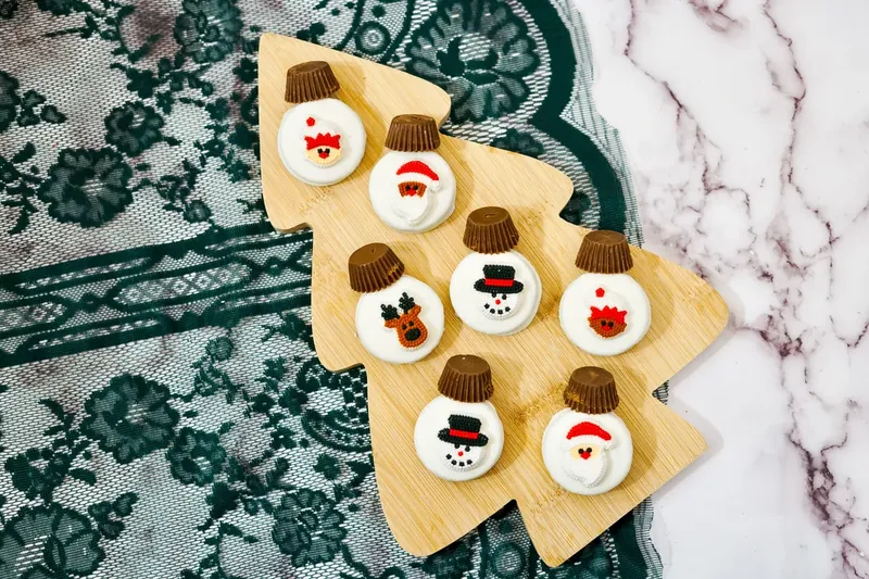 Christmas Oreos with candy designs and mini Reese's cup toppers attached
