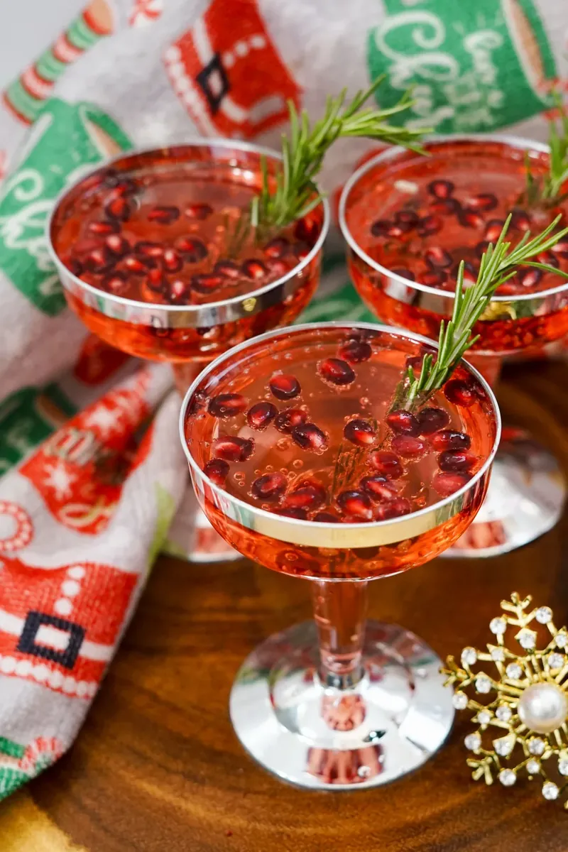 Sparkling Christmas pomegranate mimosas with floating pomegranate seeds