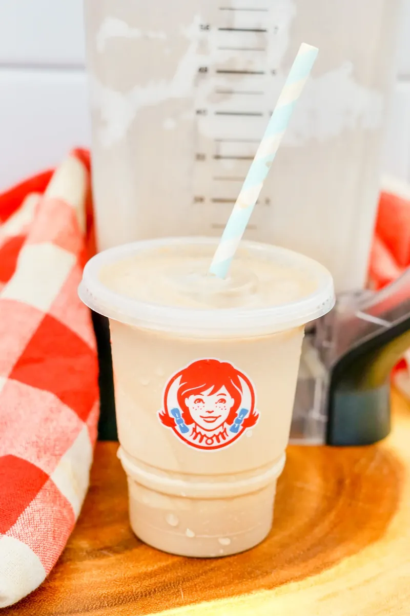 Finished copycat Wendy's Frosty ready to serve with blue striped straw