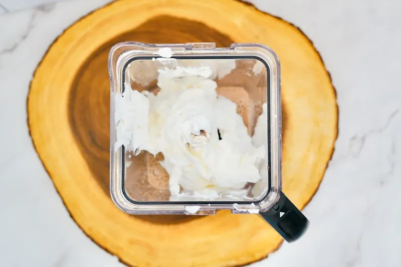 Cool Whip being added to chocolate milk in blender