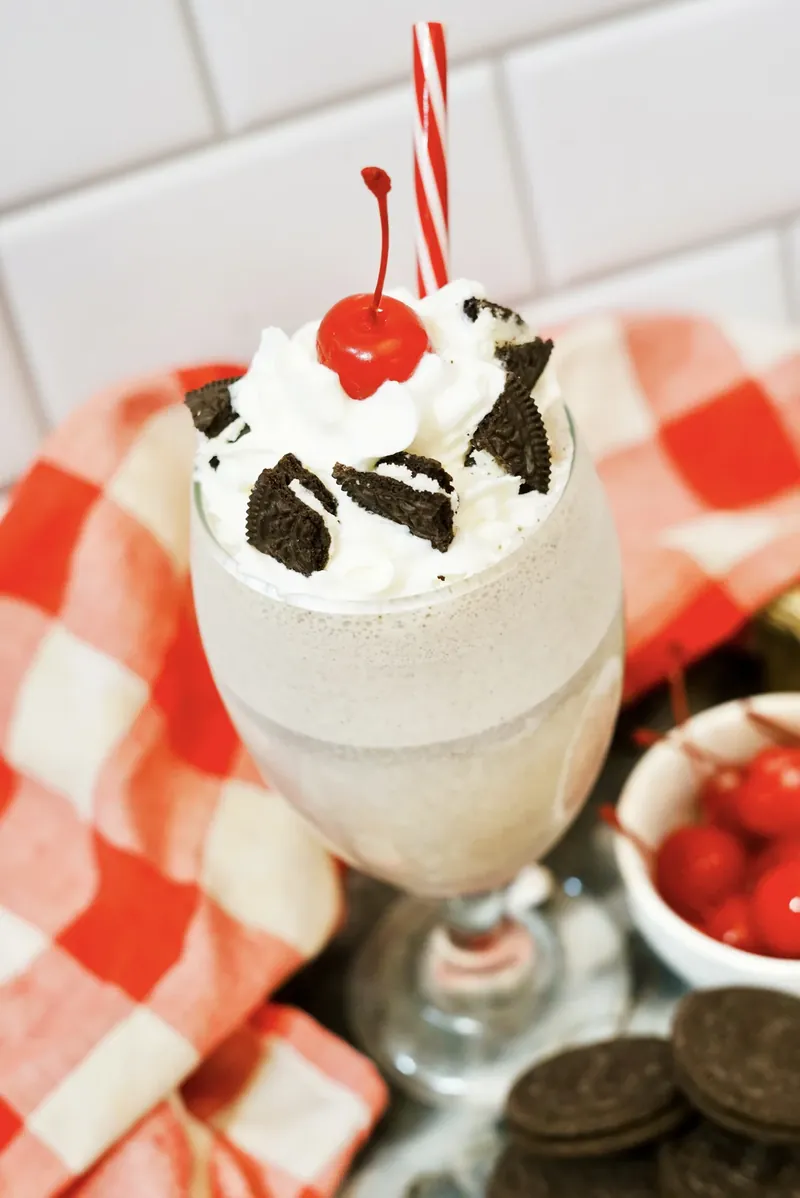 Close up view of cookies and cream milkshake showing creamy texture and Oreo pieces