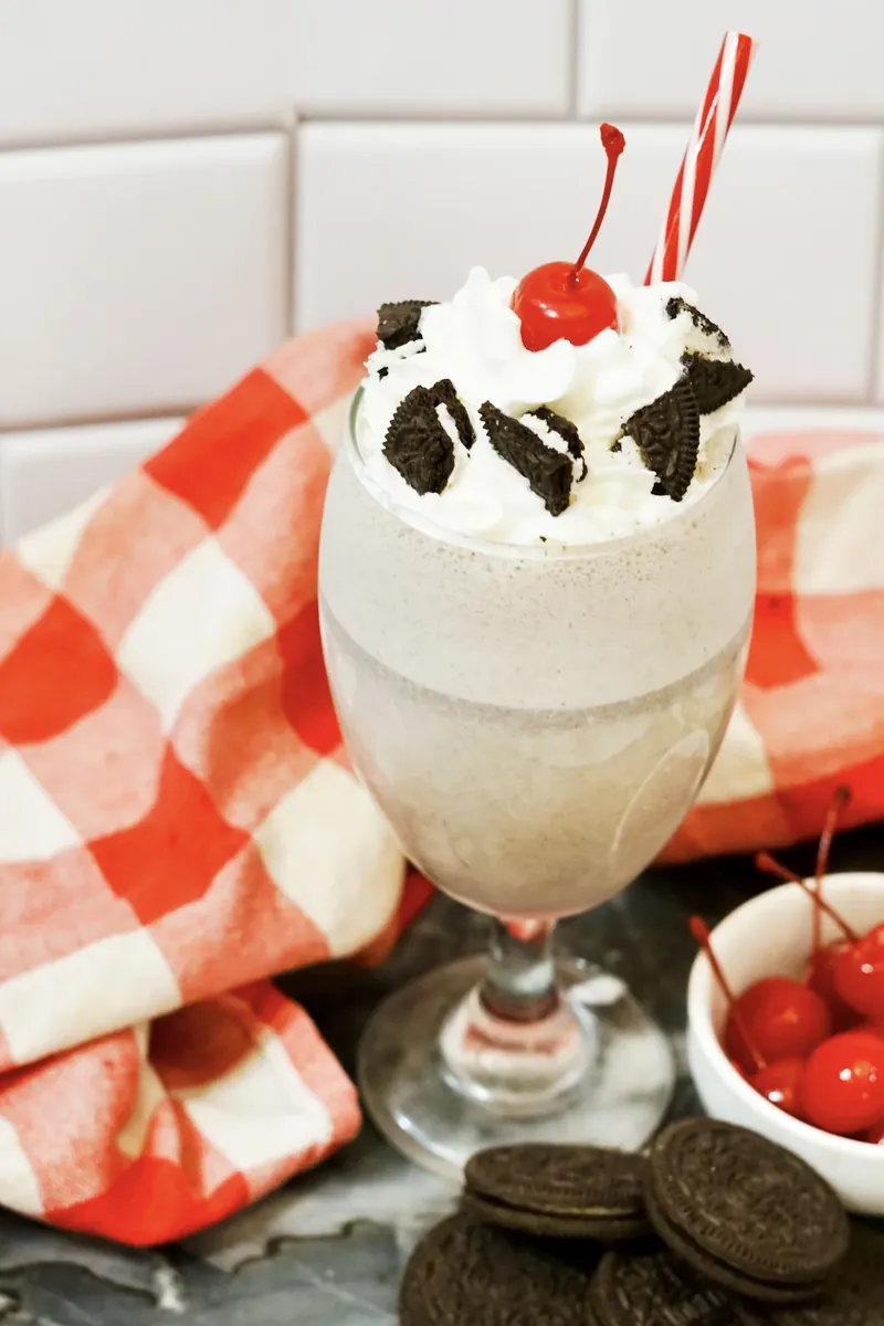 Finished Chick-fil-A copycat milkshake with red and white striped straw ready to drink