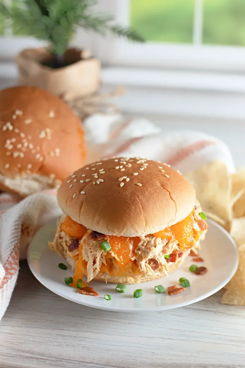 Single crack chicken sandwich on sesame seed bun with melted cheese dripping