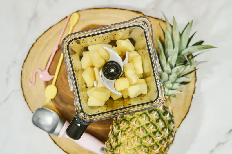 Frozen pineapple chunks in blender for Disney Dole Whip recipe