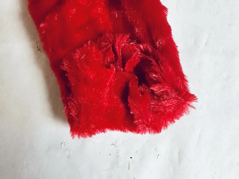 Tracing hand outline on back of green faux fur fabric with pointed fingers for Grinch hand