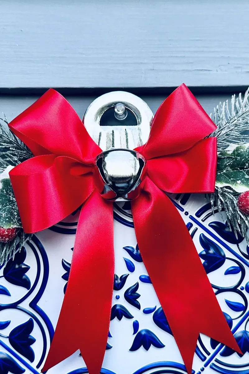 Dollar Tree ornament wreath hanging on blue siding showing complete finished project
