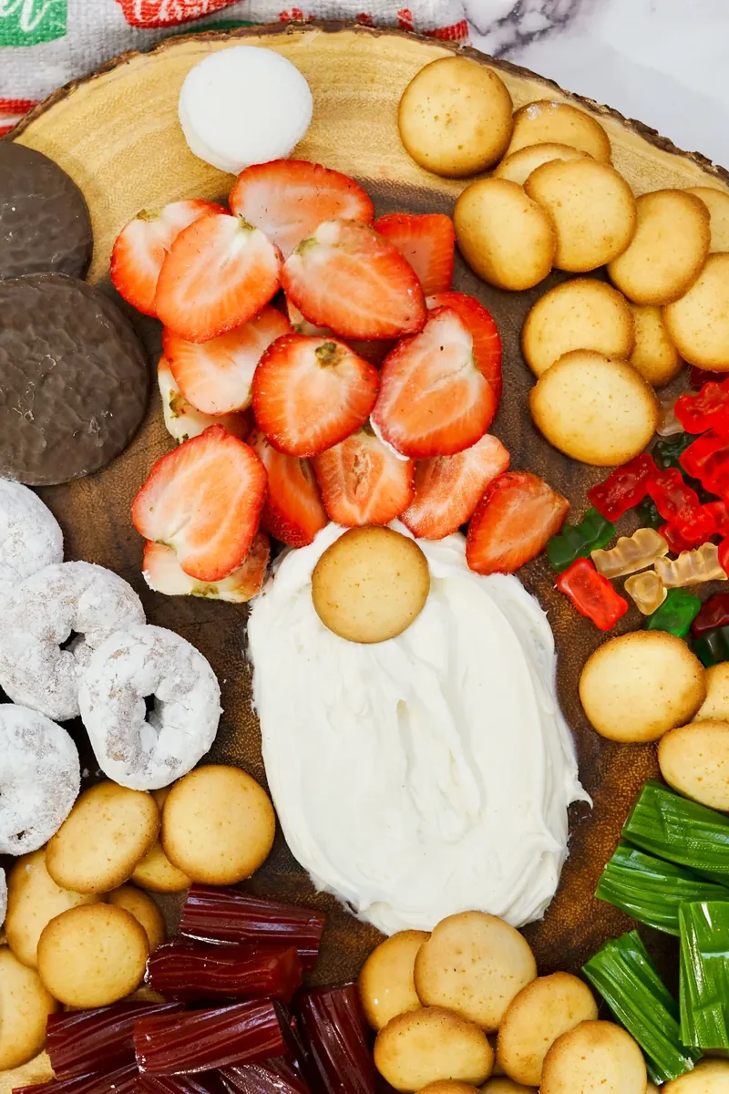 Close-up view of gnome frosting board showing detailed arrangement of strawberry hat, frosting beard, and cookie nose