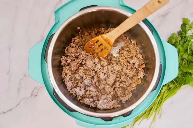 Fully cooked ground sausage in Instant Pot broken into small pieces