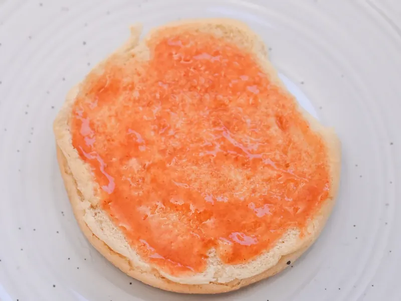 Homemade Arby's sauce spread on keto bun