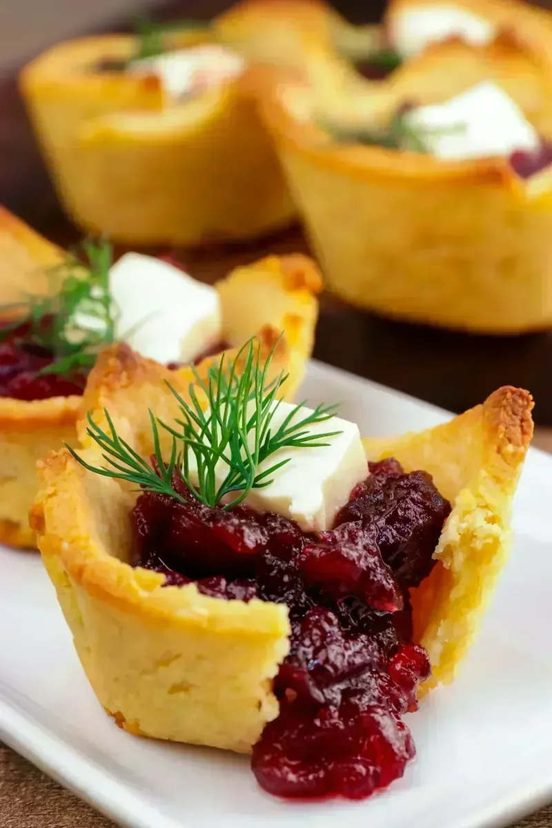 Close-up of keto cranberry brie bite showing melted cheese and cranberry filling