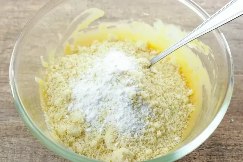 Mixing almond flour into cheese mixture for keto cranberry brie bites