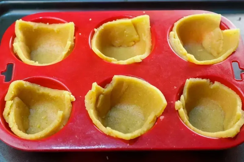 Pre-baked keto pastry shells in red silicone muffin tin