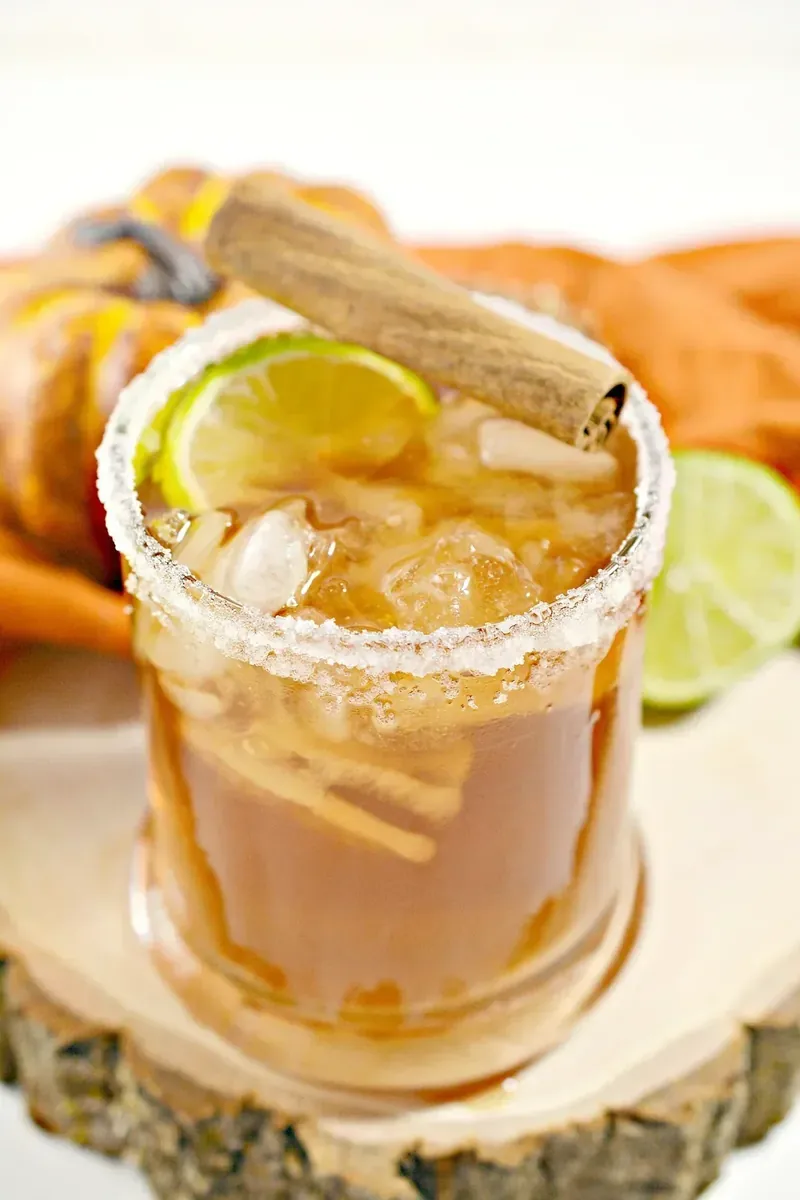 Keto margarita with autumn pumpkin decorations and cinnamon stick
