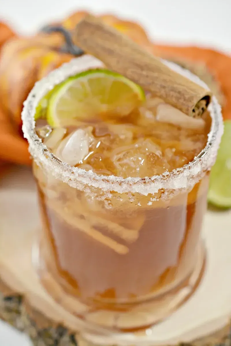 Close up view of keto thanksgiving margarita showing amber color and salt rim