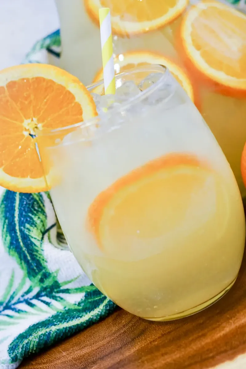 Close up of mimosa sangria in glass with orange garnish
