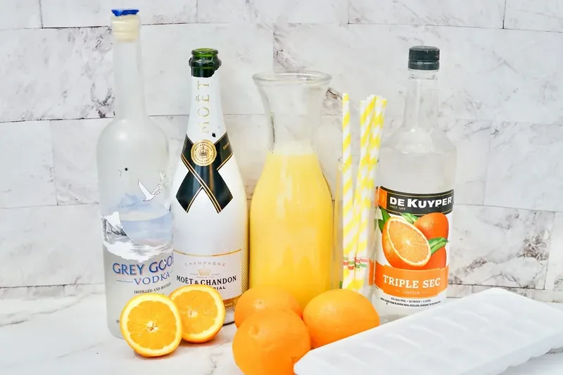 Champagne, vodka, triple sec, orange juice and fresh oranges for mimosa sangria
