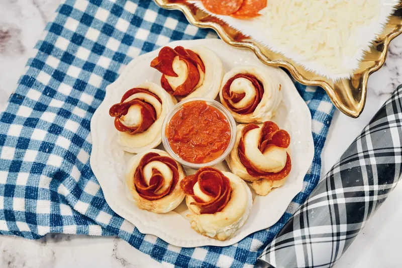 Pepperoni rose balls served on decorative plate with dipping sauce