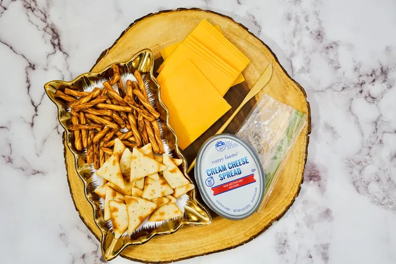 Ingredients for pie cheese crackers: triangle crackers, cheddar cheese, cream cheese, pretzel sticks