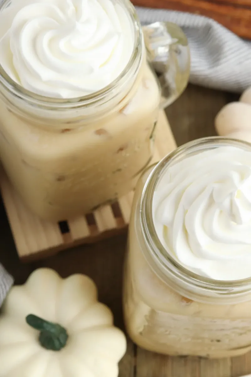 Two servings of pumpkin sweet cream cold brew with whipped cream tops