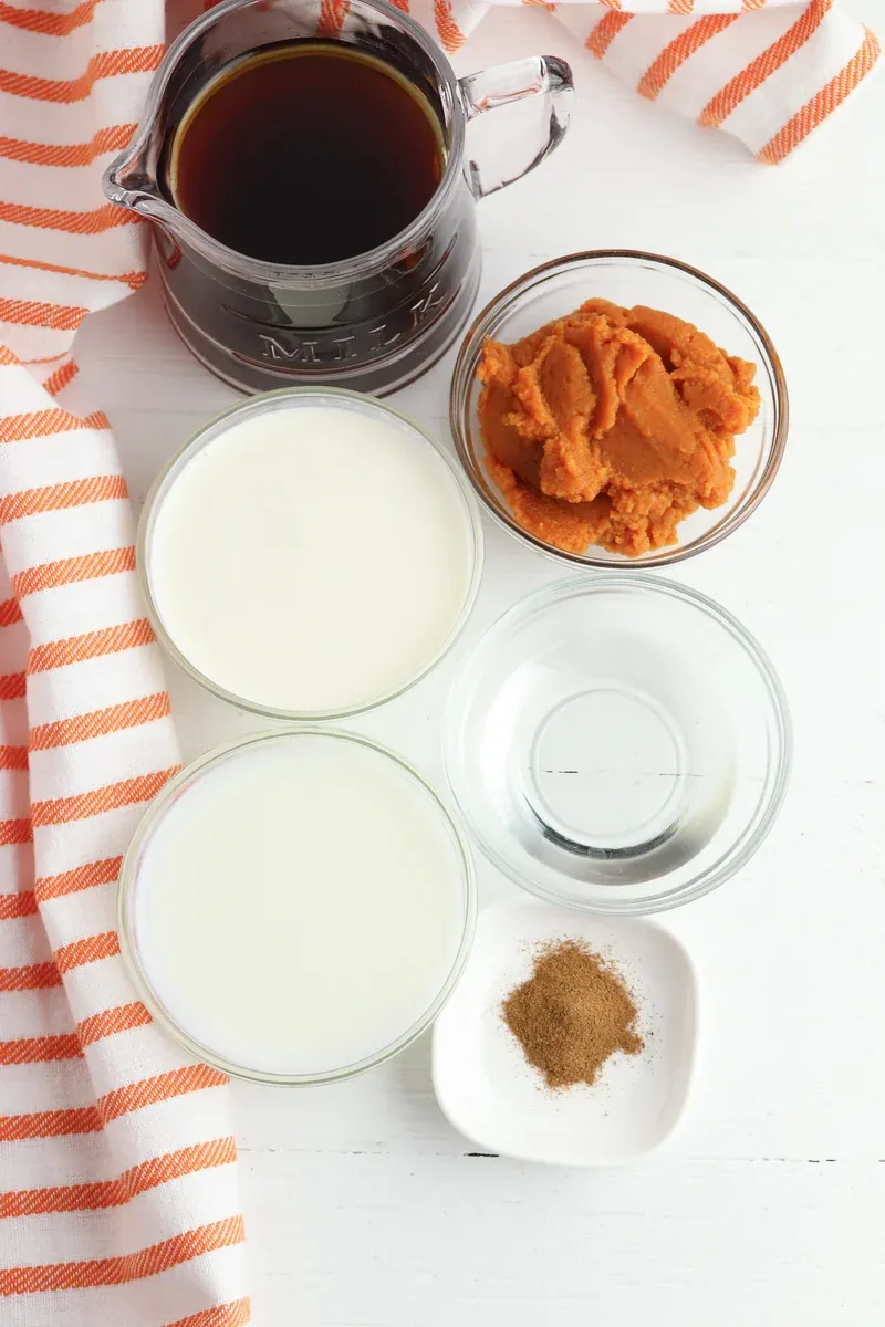 Ingredients for pumpkin sweet cream cold brew laid out including pumpkin puree, milk, cream