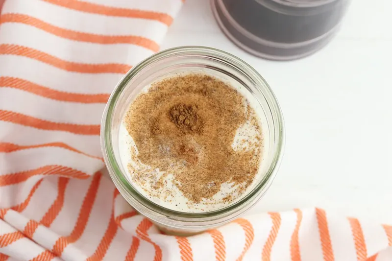 Pumpkin puree, cream, milk and spices mixed in glass jar