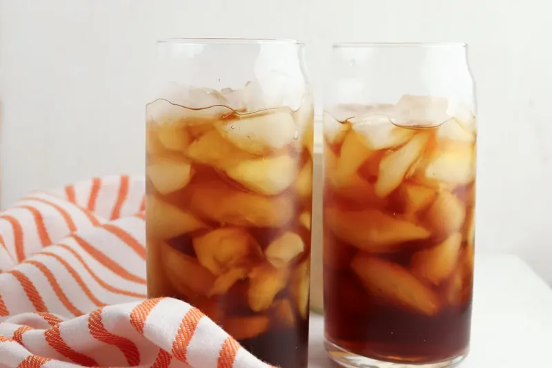 Two glasses with ice and cold brew coffee ready for cream topping