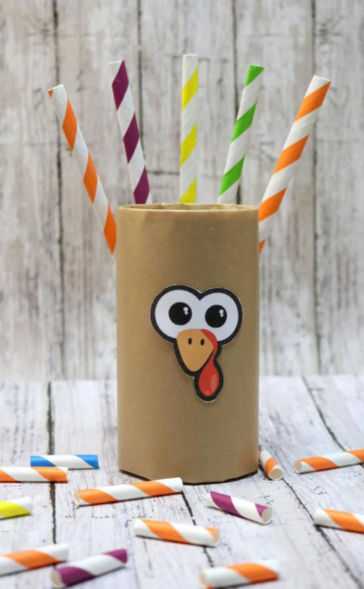 DIY toilet paper roll turkey craft with striped paper straws as feathers and turkey face decoration