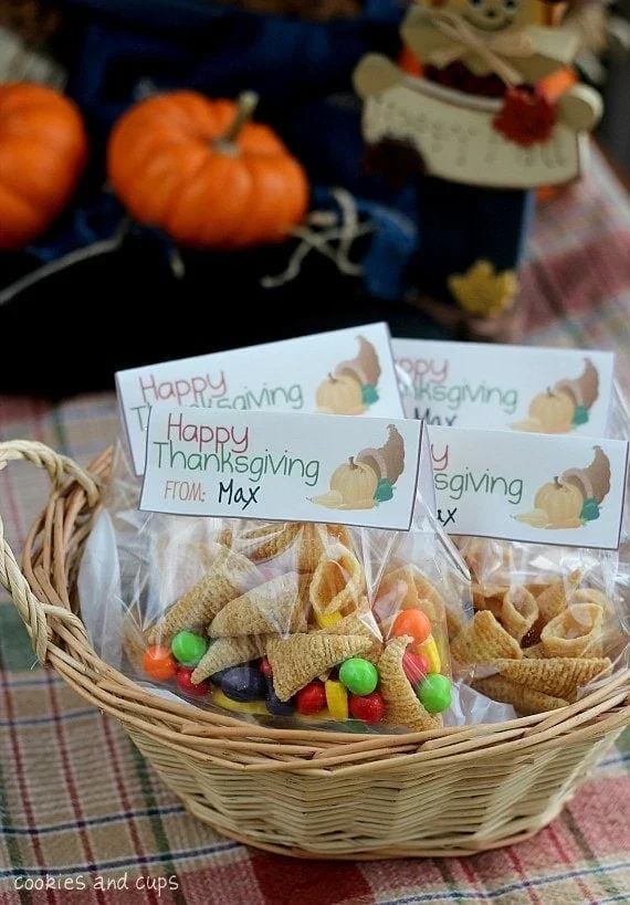 Cellophane bags filled with colorful trail mix and Happy Thanksgiving gift tags in wicker basket
