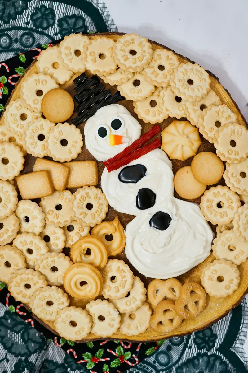 Final snowman frosting board with festive presentation ready for holiday party serving