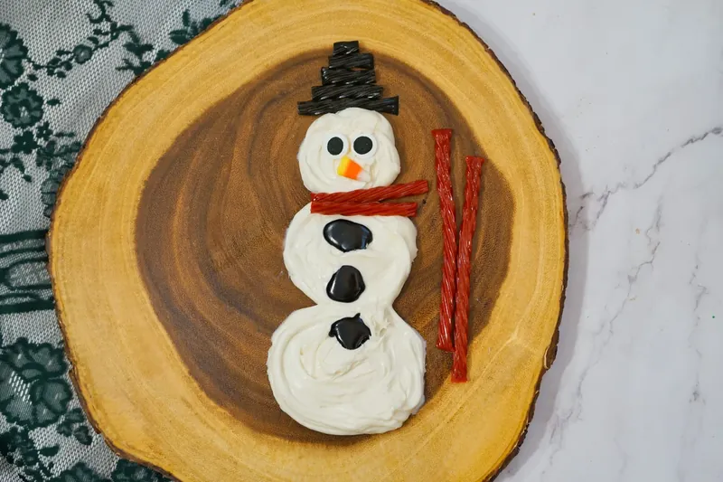 Red Twizzlers placed around snowman neck area to create scarf decoration