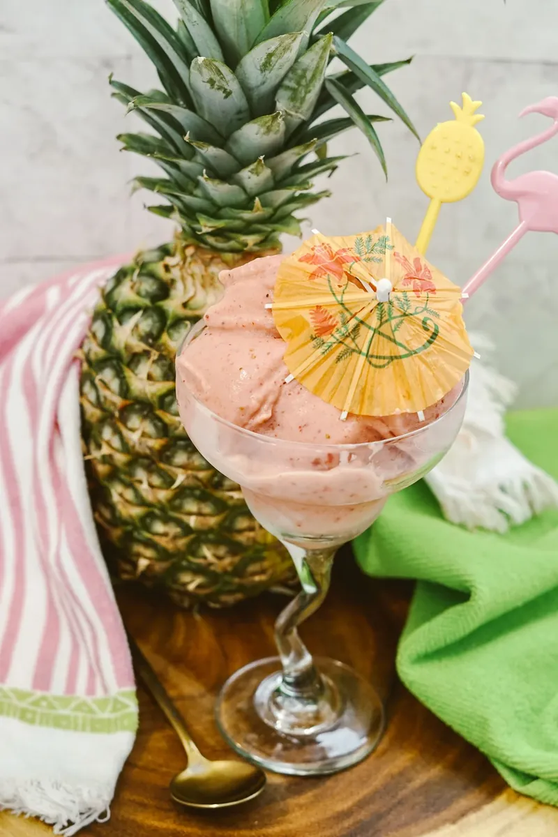 Strawberry dole whip showing perfect creamy swirl texture with tropical garnish