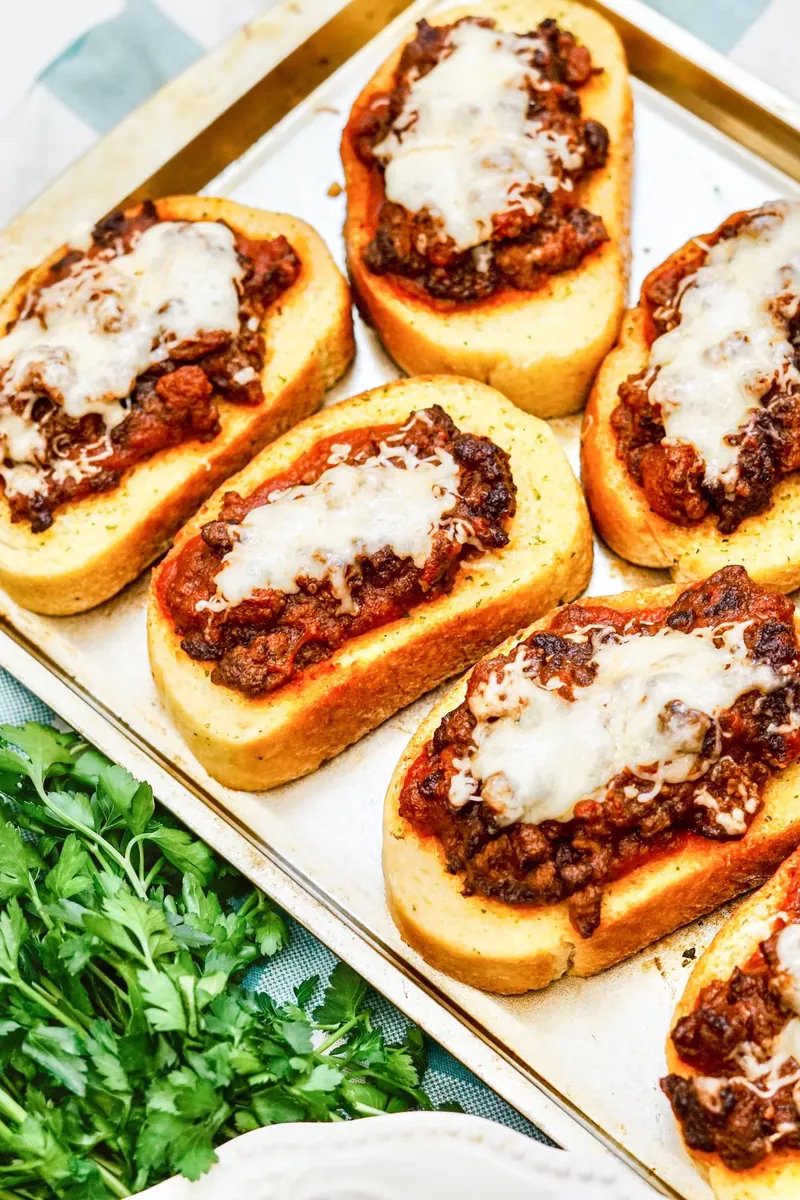 Texas Toast Sloppy Joes with melted mozzarella cheese on baking sheet