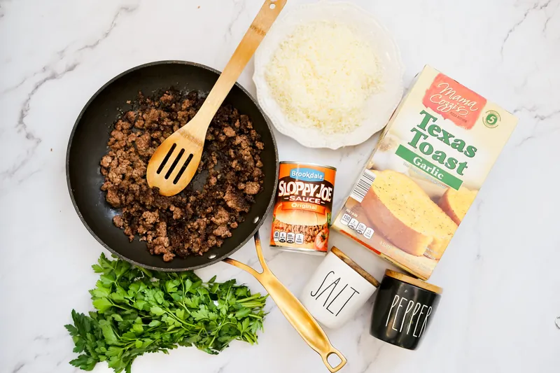 Ingredients for Texas Toast Sloppy Joes including ground beef, sauce, cheese, and bread