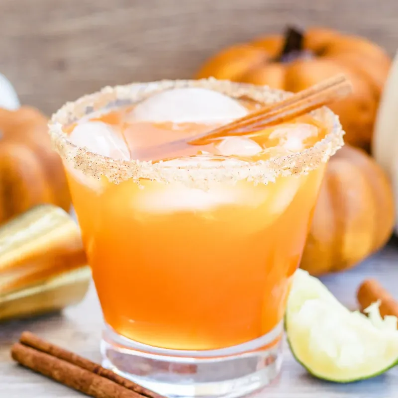 Thanksgiving margarita with pumpkins and autumn decorations