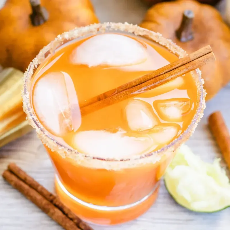 Top view of thanksgiving margarita with ice and cinnamon stick garnish