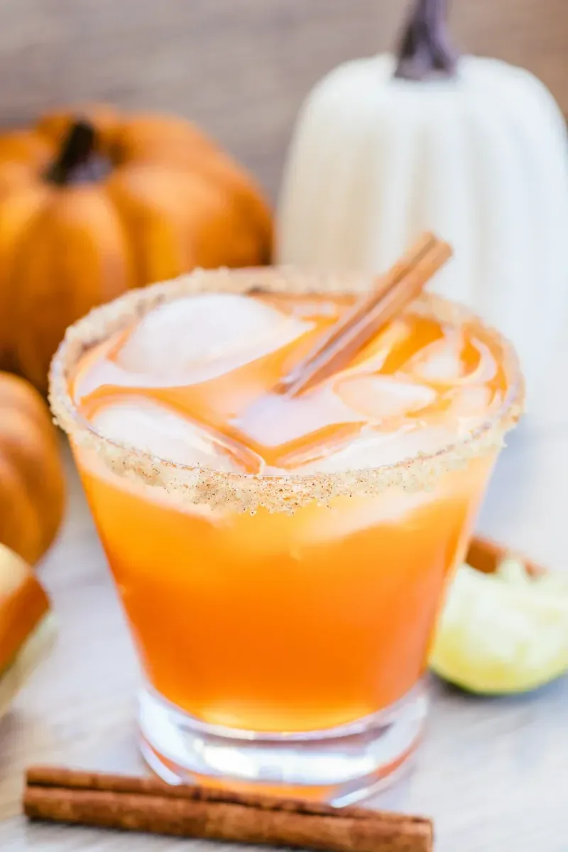 Fall margarita with cinnamon sugar rim and seasonal pumpkin decorations