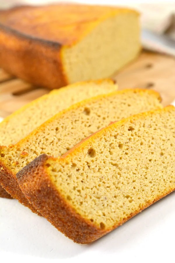 sliced pumpkin spice bread loaf showing moist golden crumb texture on cutting board