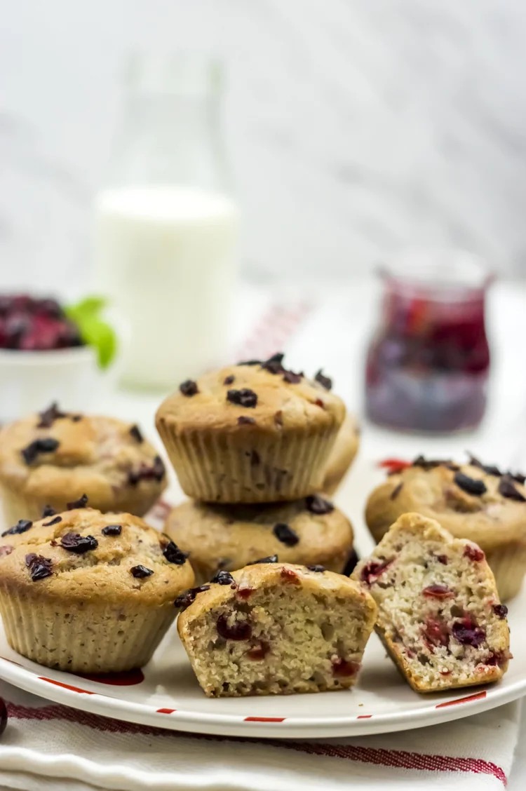 cranberry orange muffins with visible berries, some cut in half showing interior texture