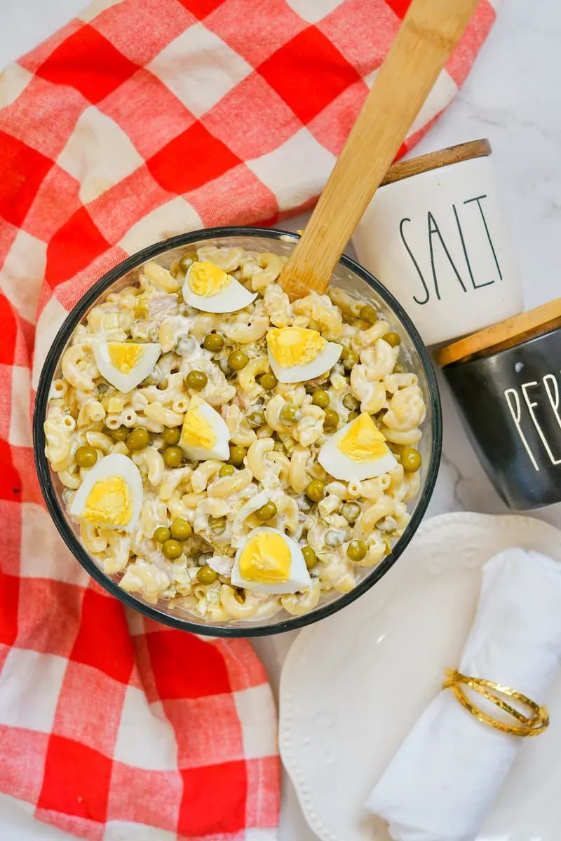 Final tuna mac salad with visible hard boiled egg pieces and peas