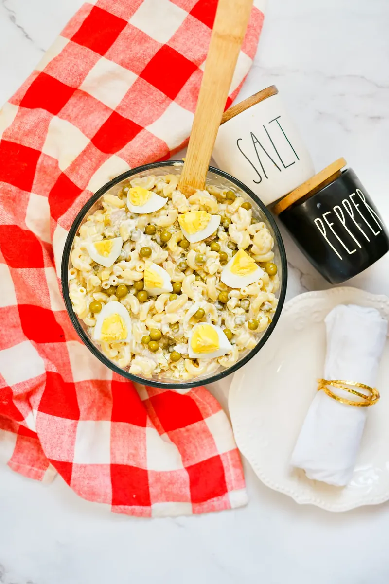 Tuna mac salad bowl with salt and pepper shakers and checkered napkin