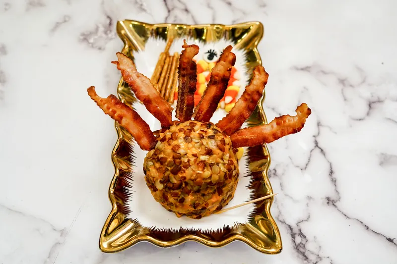 Turkey cheese ball with candy eyes and bacon feathers
