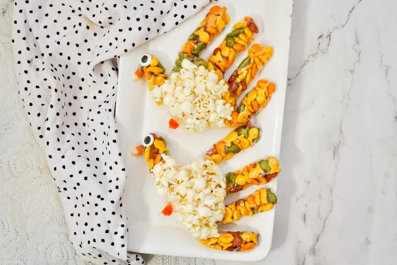 Festive autumn turkey treat bags with popcorn and colorful snacks for Thanksgiving party favors