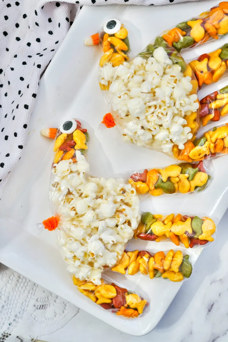 Multiple turkey treat bags arranged on white tray showing completed Thanksgiving snacks