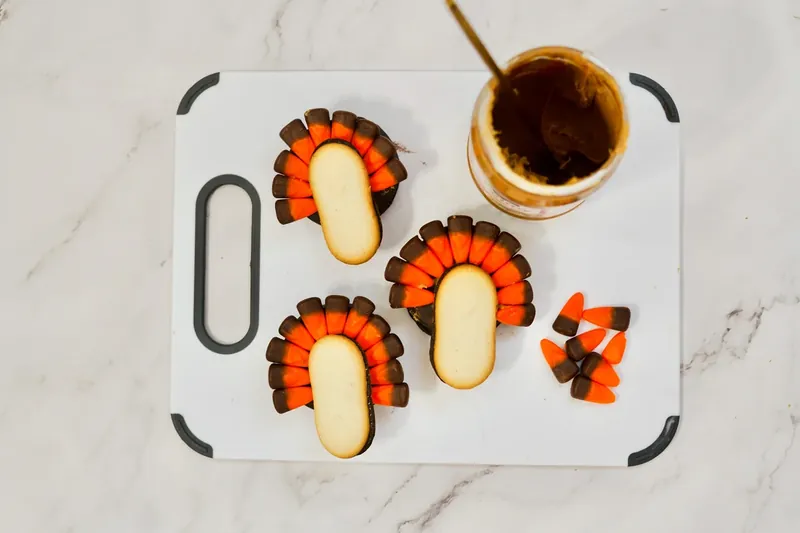 Turkey cookies with candy corn feathers fully arranged in fan pattern