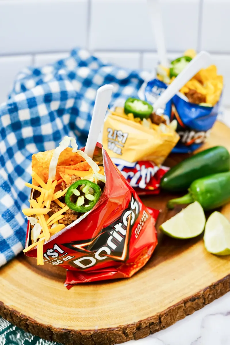 Walking tacos on wooden board ready for serving at party