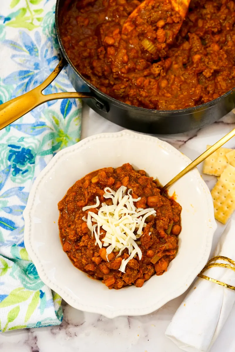 White bowl filled with homemade Wendy's copycat chili topped with cheese