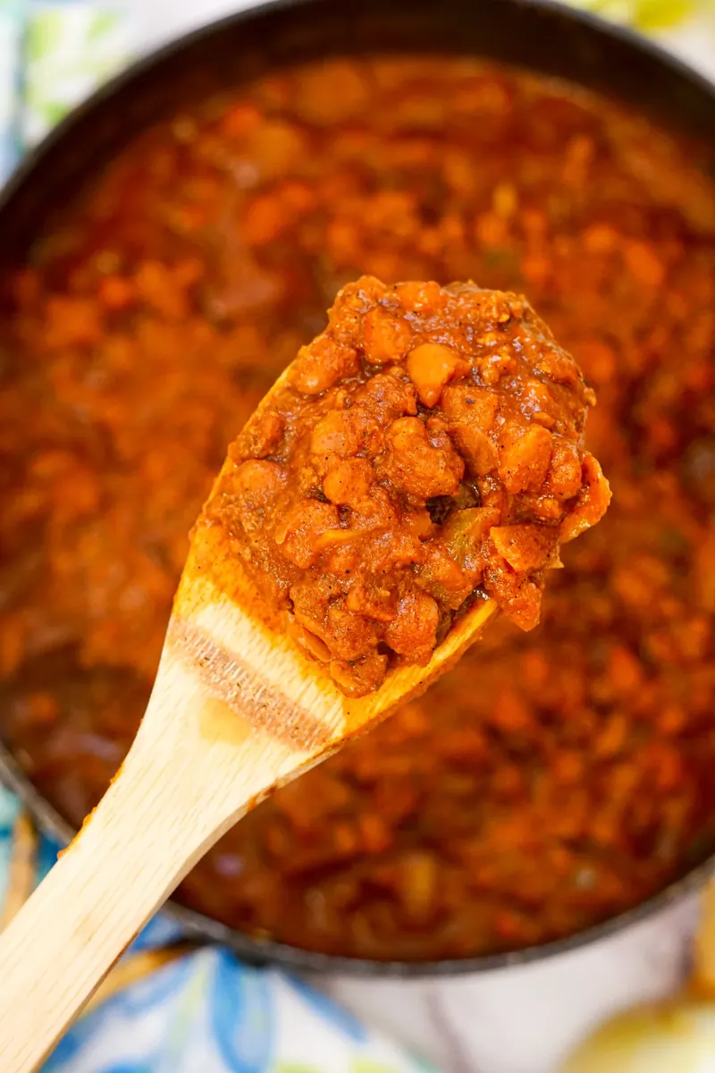 Close-up of wooden spoon filled with Wendy's copycat chili showing beans and ground beef