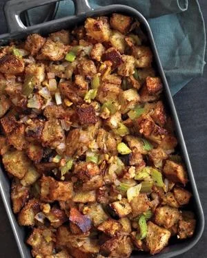 Golden brown herb stuffing with celery and onions in black baking dish